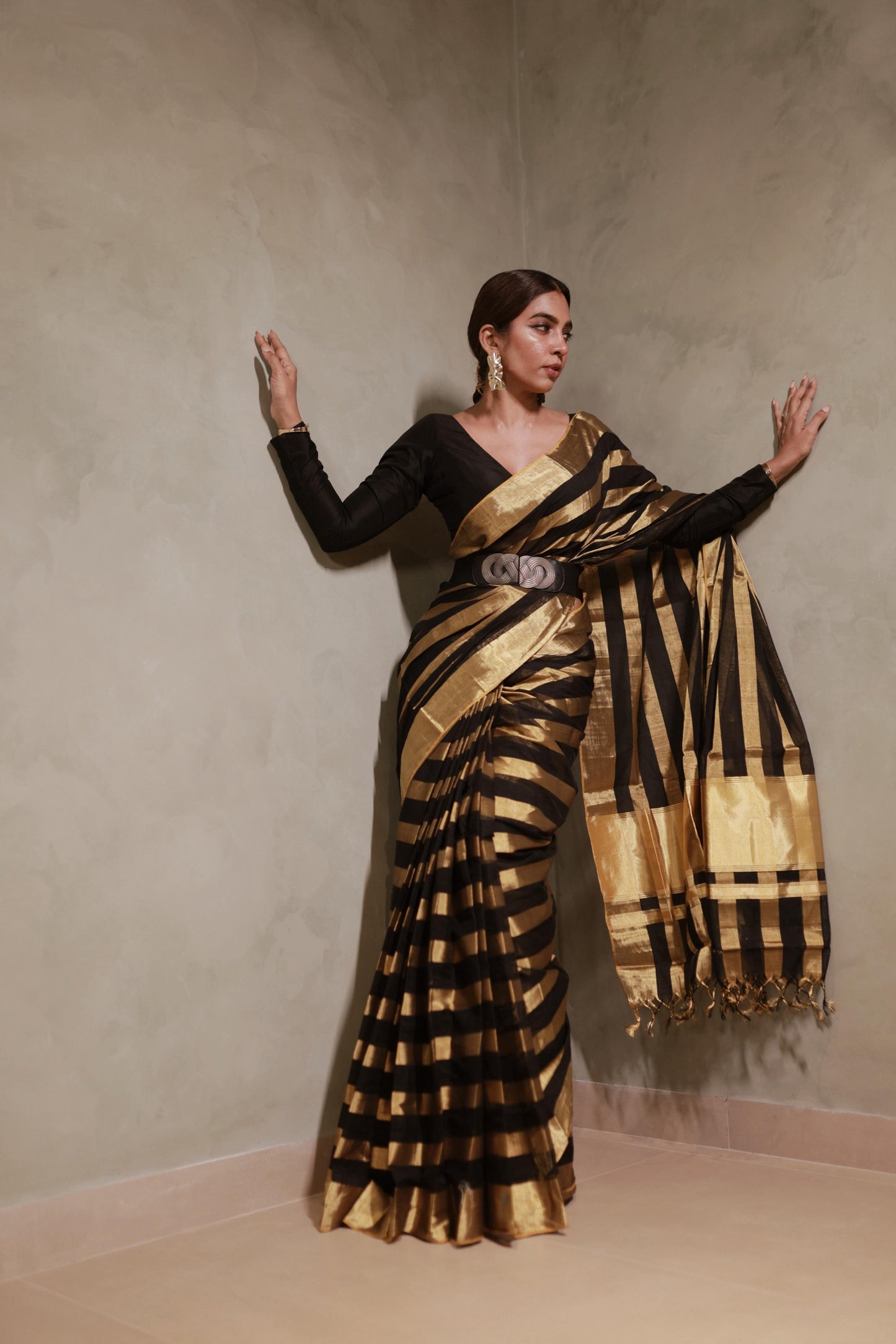 Full-length front view of the black and gold kasavu broad striped handloom saree with matching black blouse