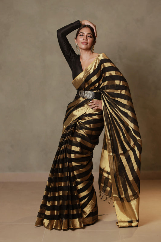Model wearing the Pure Handloom Black & Gold Striped Kerala Saree, front view showing the full drape and pallu