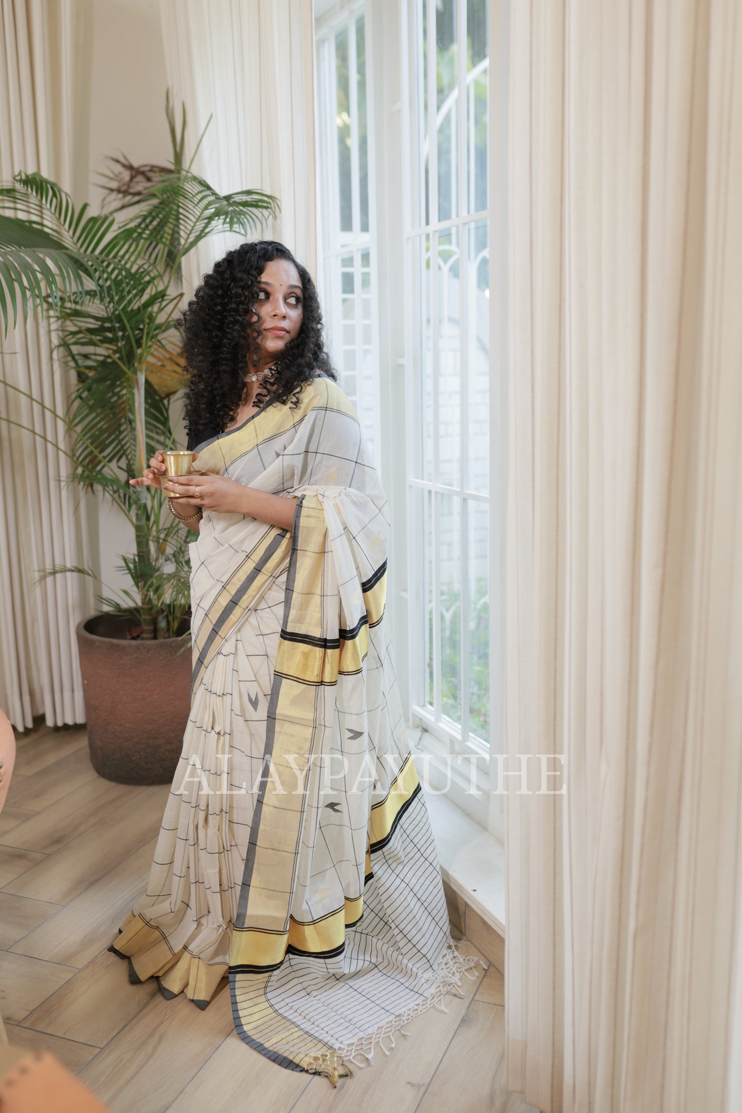 Pure Handloom Black Checks Kasavu Saree on model, three-quarter standing view showing the full drape and pallu