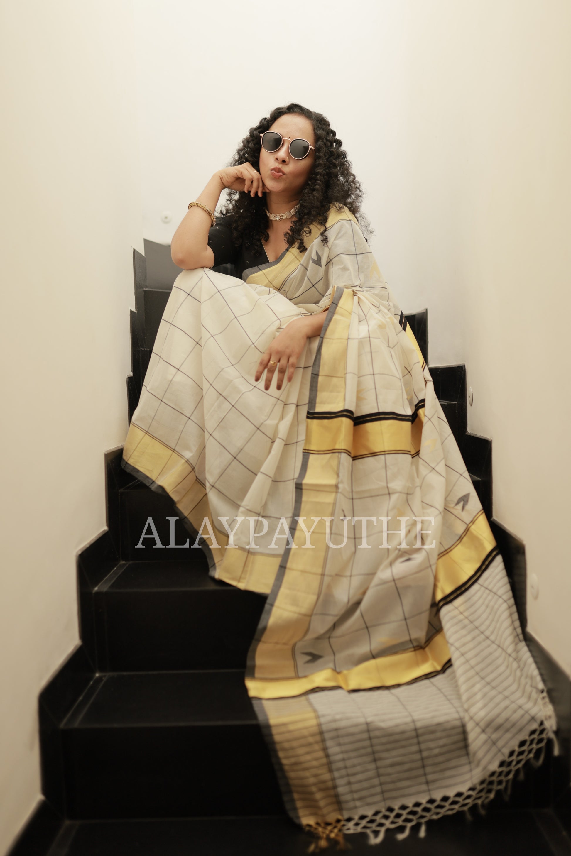 Pure Handloom Black Checks Kasavu Saree, pallu spread out showing the woven motifs and knotted tassel fringe