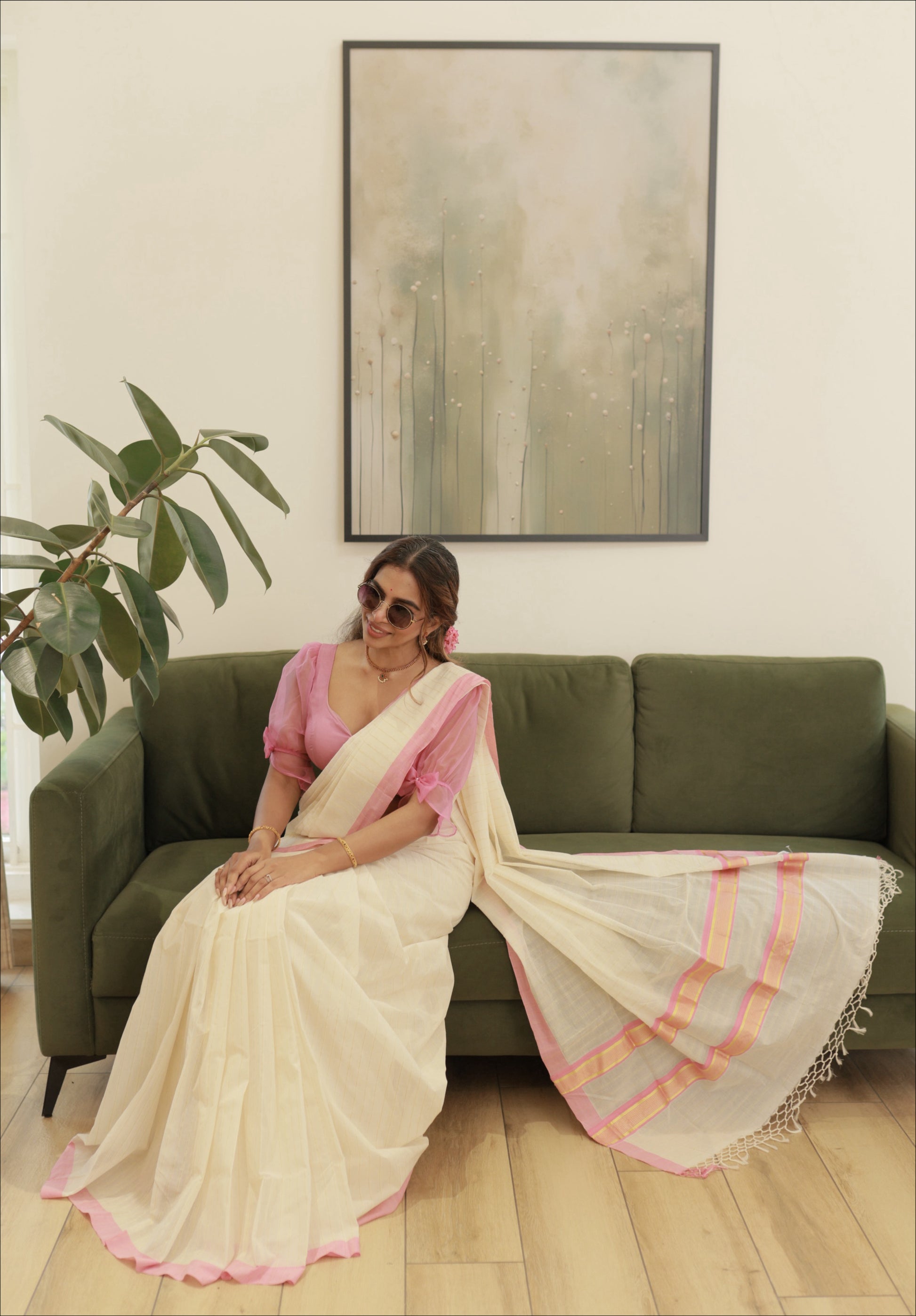Pure Handloom Pink Striped Kasavu Saree, seated model showing the pallu with golden kasavu and knotted fringe